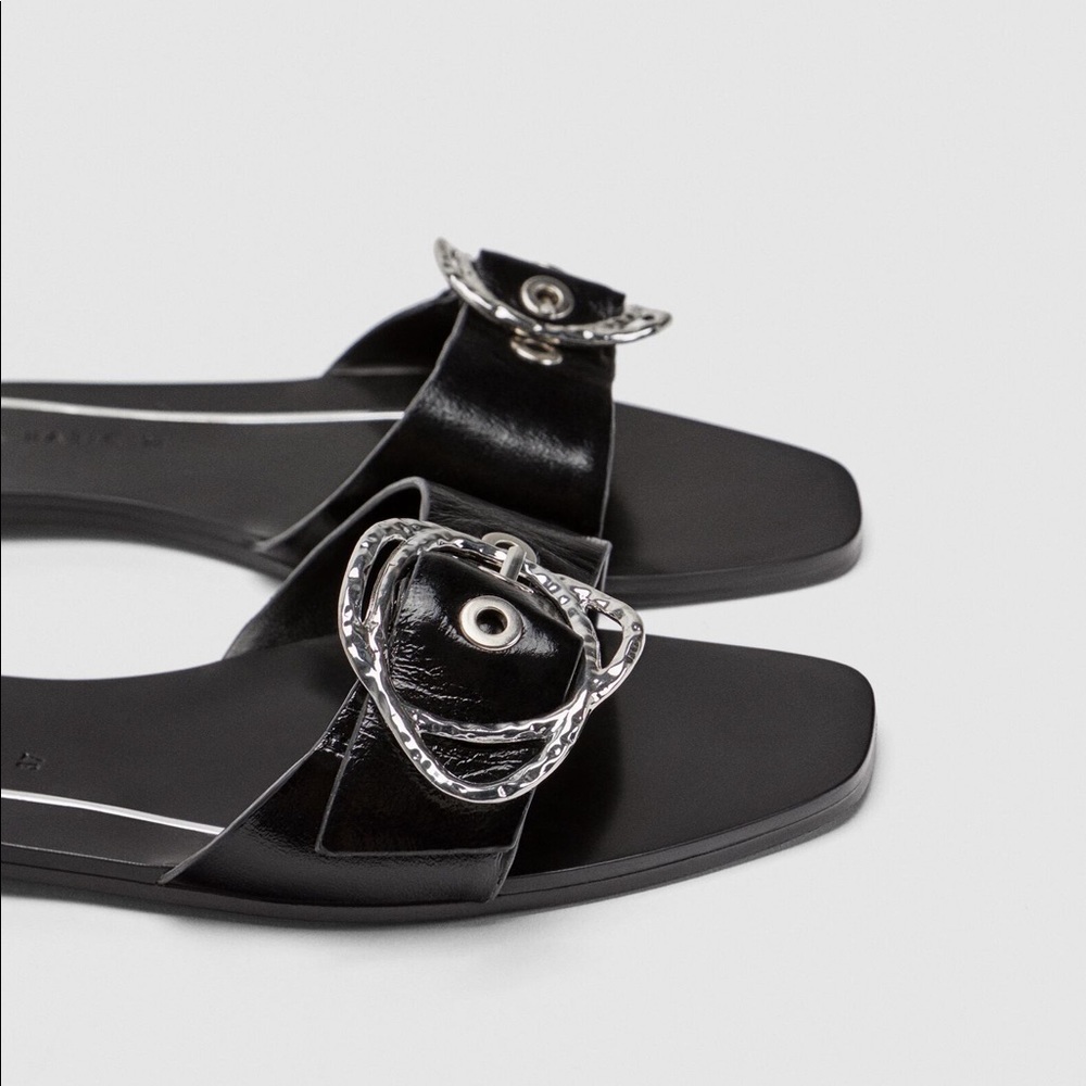 Zara Flat leather slides with buckle detail.
